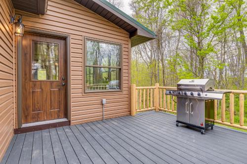 a house with a grill on a wooden deck at Family-Friendly Milton Home on 14 Acres with Hot Tub in Milton