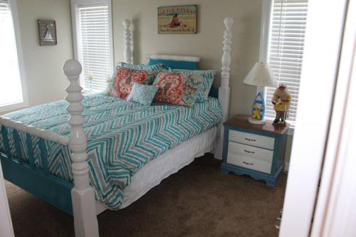 1 dormitorio con 1 cama con edredón azul en 2510 Beach Rd, Semi-Oceanfront/Pool/Hot Tub, en Nags Head