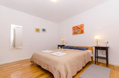 a bedroom with two beds and a mirror at Apartment City Center in Jelsa