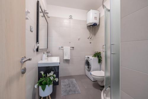 een witte badkamer met een toilet en een wastafel bij Leona apartment in Split
