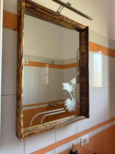 a mirror on the wall of a bathroom with a tub at Villa Verde Vlore in Vlorë