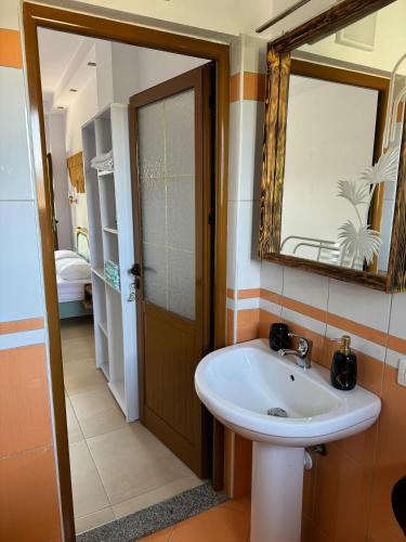 a bathroom with a sink and a mirror at Villa Verde Vlore in Vlorë