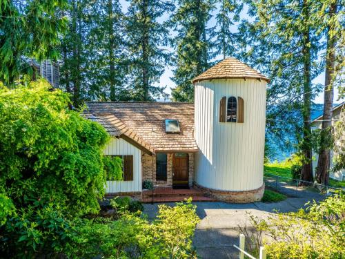 a small house with a tower on top of it at Fairyland Cottage, Waterfront, Beach, Kayak, Hot tub in Poulsbo