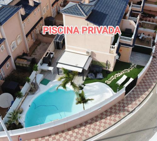 a villa with a swimming pool at a resort at Tu Playa paradisiaca PRIVADA in Gran Alacant