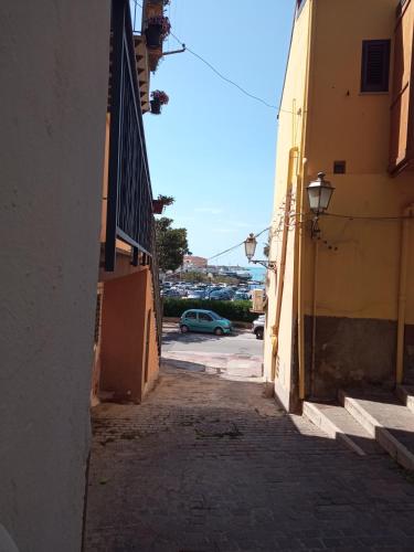 an alley with a car parked in a parking lot at Torre Carlo V in Porto Empedocle