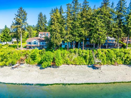 an aerial view of a house with trees and the water at Fairyland Cottage, Waterfront, Beach, Kayak, Hot tub in Poulsbo