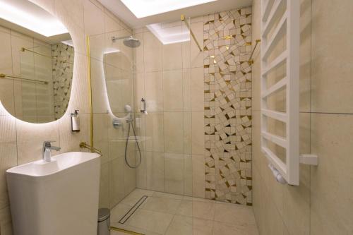 a bathroom with a shower and a sink at Boulevard Boutique Suites in Łeba