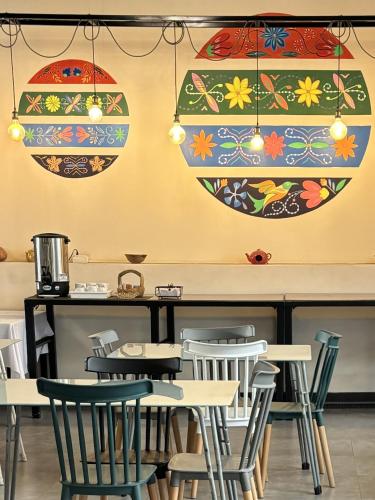 a dining room with tables and chairs and lights at Los Andes Bed & Breakfast in Arequipa