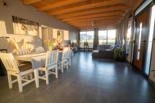 a dining room and living room with a table and chairs at Palomino house in Sinj