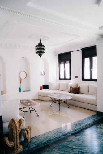 a living room with a couch and a table at Riad Searenity in Tamraght Ouzdar