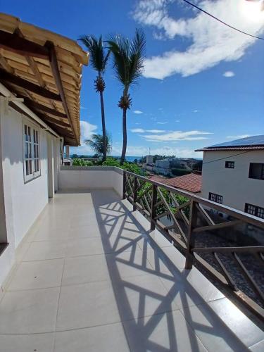 a balcony with a view of the ocean and palm trees at Milano Hotel Pousada Canoa Quebrada in Canoa Quebrada