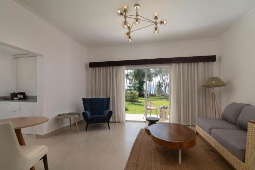 a living room with a couch and a table at Wyndham Alltra Samana All Inclusive Resort in Las Galeras