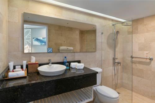 a bathroom with a sink and a toilet and a shower at Wyndham Alltra Samana All Inclusive Resort in Las Galeras