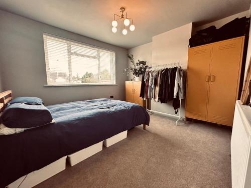 a bedroom with a bed and a window at Chic Family Home Near Parks & Leicester Uni in Leicester