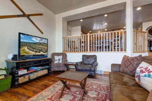 a living room with a couch and a tv at Bear Hollow Village 5437 by Moose Management in Park City