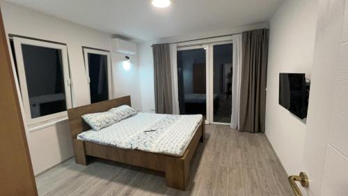 a bedroom with a bed in a room with windows at Old Town Hideaway in Sarajevo
