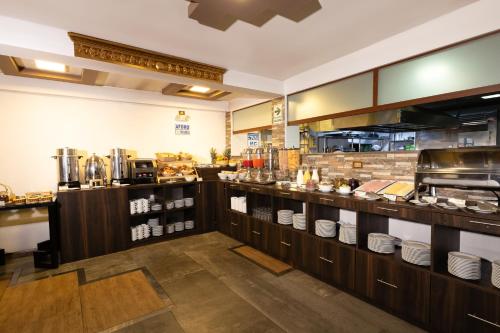 a restaurant kitchen with a counter with dishes at Hotel Hacienda Cusco Centro Historico in Cusco