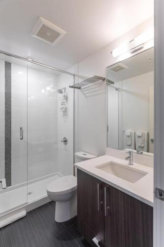 a bathroom with a toilet and a sink and a shower at Urban Stay With Balcony And In-Unit Laundry in Victoria