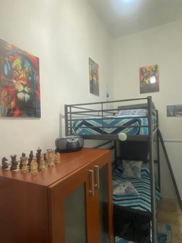 a bedroom with a bunk bed and a desk with a chessboard at SUNRISE ACITREZZA in Acitrezza
