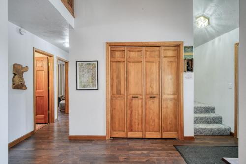 a hallway with a wooden door and some stairs at Wapiti View 6-Bedroom Cabin 28mins to Yellowstone in Island Park