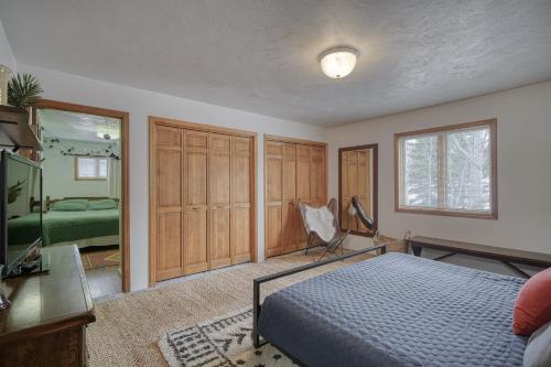 a bedroom with a bed and a desk and a mirror at Wapiti View 6-Bedroom Cabin 28mins to Yellowstone in Island Park