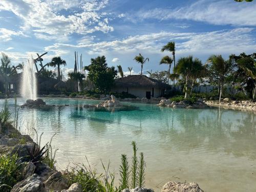a large pool of water with a fountain at punta beach bavaro hotel apartamentos in Punta Cana