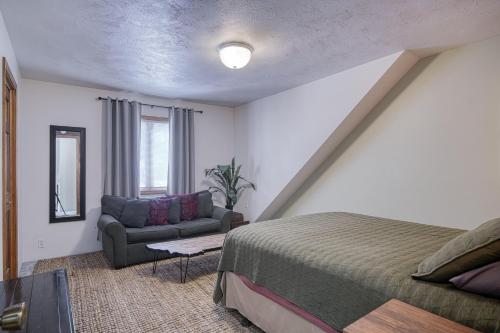a bedroom with a bed and a couch at Wapiti View 6-Bedroom Cabin 28mins to Yellowstone in Island Park