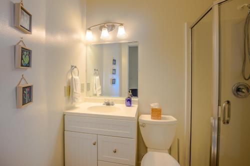 a bathroom with a toilet and a sink and a mirror at Blue House - private 2 bed, 2 bath home with garage in Eugene