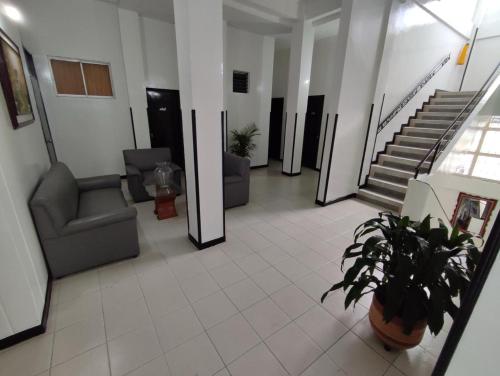 eine Lobby mit Stühlen und Treppen in einem Gebäude in der Unterkunft Hotel Cinema in Bucaramanga