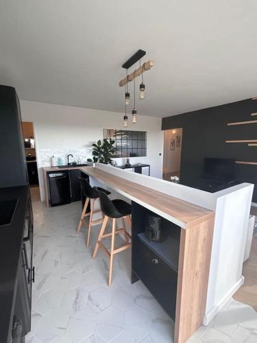 a kitchen with a large counter in a room at Appartement T2 en résidence privée in Maurepas