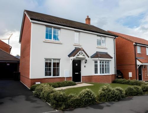 a white house with a black door at Spacious & Stylish 4-Bed House with Hot Tub in Prime Location in Southampton