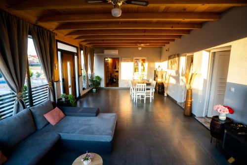 a living room with a blue couch and a table at Palomino house in Sinj