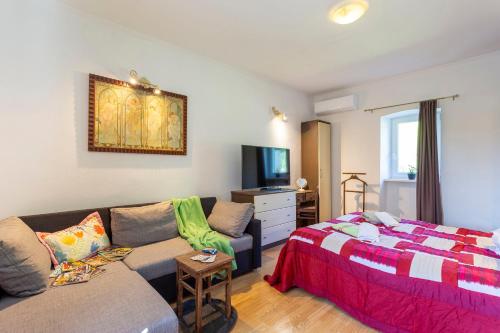 a living room with a bed and a couch at House Gioia Cristina in Labin