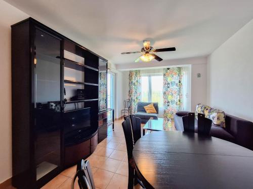 a dining room with a table and a ceiling fan at Apartment Selce in Selce