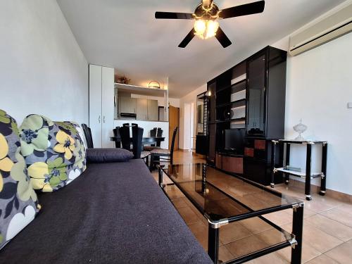 a living room with a couch and a ceiling fan at Apartment Selce in Selce