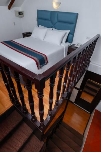 a bed sitting on top of a stair case at Hotel Hacienda Cusco Plaza in Cusco