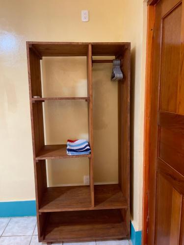 a wooden book shelf in a room at Apartments at Los Delfines Little Corn in Little Corn Island
