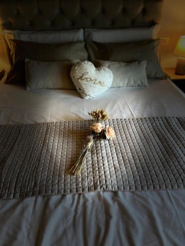 a key on a bed with flowers on it at My Tuscany Relais in Altopascio