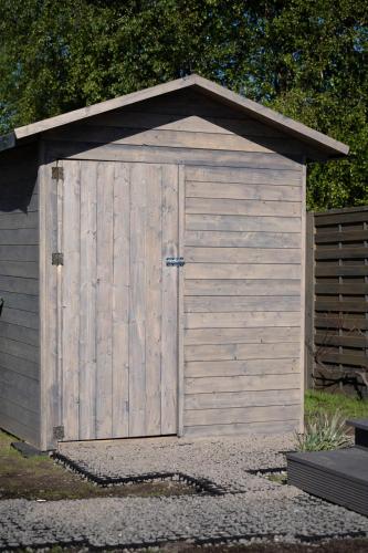 a wooden garage with a large door on it at Domki Stolem in Jastarnia