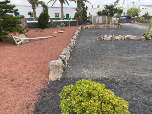 a herd of sheep in a yard with rocks at Casa Carla in La Vegueta