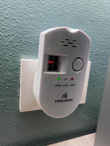 a white lightswitch on a wall with a green light at Appartamento Anna - Comfort e Stile in Centro Storico in Imola