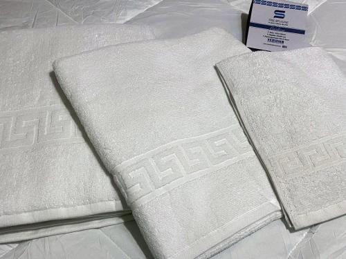 two white towels sitting on top of a bed at Appartamento Anna - Comfort e Stile in Centro Storico in Imola