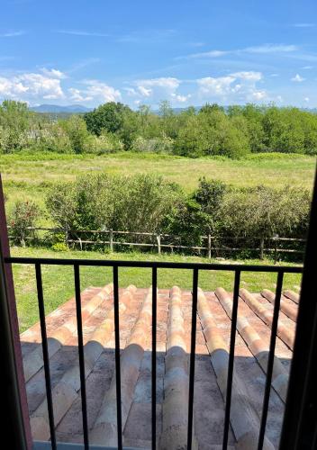 a view of a field from a balcony at My Tuscany Relais in Altopascio