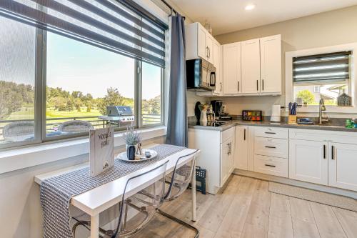 a kitchen with a table and a large window at Modern Studio Suite in Sandy Point on Lummi Bay! in Ferndale