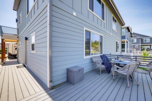 a deck with a table and chairs on a house at Modern Studio Suite in Sandy Point on Lummi Bay! in Ferndale