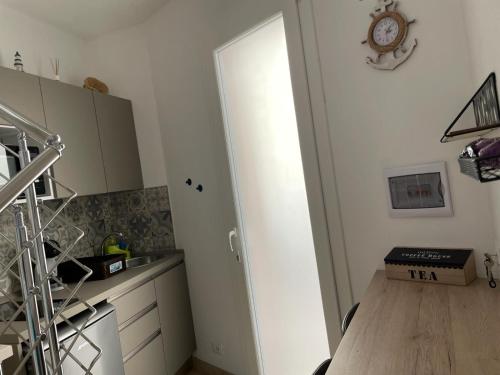 a kitchen with a door leading into a kitchen with a table at Casa dei Mulini in Favignana