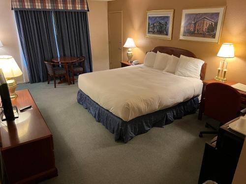 a hotel room with a bed and a desk at Hardman House in Carson City