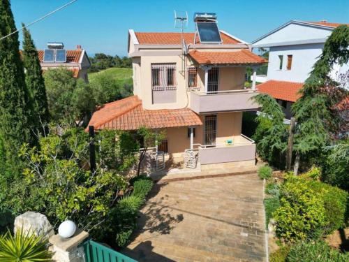 a house with a staircase leading up to it at Lilian Luxury Villa Halkidiki in Nea Fokea