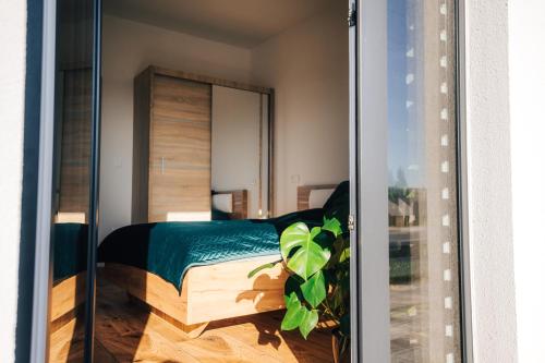 a bedroom with a bed and a mirror at Apartmány Na Vŕšku in Kežmarok