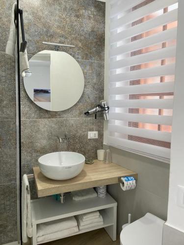 a bathroom with a sink and a mirror at Casa dei mulini in Favignana